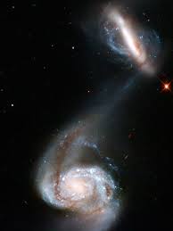 Ngc 2608 is a spiral galaxy in the cancer constellation. Interacting Galaxy Pair Two Galaxies Known Collectively As Arp 87 Distort As Their Gravitational Fields Inte Hubble Pictures Hubble Space Telescope Galaxies