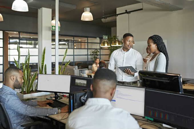 African tech professionals collaborating in a modern software office