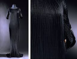 Fortuny delphos gown vintage fortuny delphos gown is made of finely pleated black silk with black silk cording along the side seams and caramel color burgundy striped murano glass beads threaded through the cording. Pleats Mccartney Miyake And Fortuny The Cutting Class