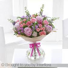 Pink flowers peonies in a vase on a wooden background with a small white gift and a happy birthday card. Happy Birthday Cottage Garden Handtied Buy Online Or Call 0800 118 2053