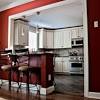 A large arch connects the open kitchen with a dining area. 3