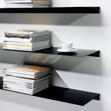 Show off your tastes by displaying books, picture frames, and decor on a stylish bookcase. Exilis Shelving Black Shallow Shelf Nonuform Touch Of Modern