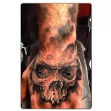 Joker skull tattoo on hand for men. Black And Grey Skull Hand Tattoo Skull Hand Tattoo Hand Tattoos For Guys Hand Tattoos