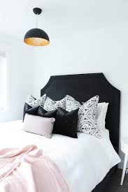 Gallery of black and white posters and photos on emerald green wall in trendy bedroom. Chic Black And White Bedroom With Pink Accents Boasts A Striking Black Head Board Positioned Against A Wh Light Pink Bedrooms Pink Bedrooms Pink Bedroom Design