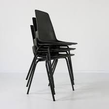 three stackable small kitchen chairs by