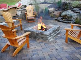 Example of a freestanding metal grate style fire pit that burns wood. Backyard Fire Pit Ideas To Transform Your Outdoor Space
