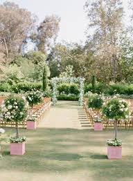 Stylish young groom and bride with wedding bouquet standing together in botanical garden. 30 Amazing Wedding Venues Spring Garden Wedding Outdoor Wedding Best Wedding Venues