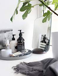 A plant gives a green, refreshing touch to contrast the clinical feel of white and gray tile. Minimal Bathroom Styling Tips Minimal Blogs