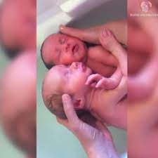 Newborn twins cling to each other for first bath time | Newborn twins cling to each other for first bath time. | By Mother and baby care | Facebook
