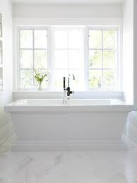 Maybe you would like to learn more about one of these? White Pedestal Bathtub With White Marble Chevron Floors Transitional Bathroom
