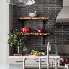 Light gray shaker cabinets are stacked beneath glass front cabinets mounted flanking a light gray range hood mounted against white subway backsplash tile s. Photos Hgtv