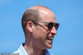 Prince William rocks his shades as he visits a surf beach in Cornwall