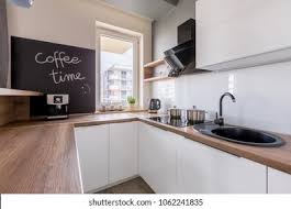 Pale grey kitchen with wood worktop maintenance man clip art. Kitchen Wooden Worktop Chalkboard White Cabinets Stock Photo Edit Now 1062241835