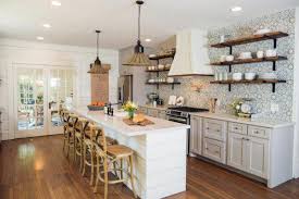 The island has a double sink and gives you both prep space and casual board and batten and clapboard siding with a stone base add to the modern farmhouse appeal. Barn House Details The Lettered Cottage Fixer Upper Kitchen Kitchen Layout Kitchen Cabinets Decor