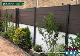 This decorative garden fence is made of wood and lifelike artificial green leaves. Fence Wpc Fence Suppliers In Dubai Wpc Garden Fence In Meadows Wpc Fencing Patio Garden Meadows Patio Garden