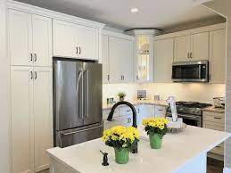 Bright Condo Kitchen With Farm Sink Eggshell Painted Cabinets Kitchendesign Cabin Kitchen Cabinetry Design Kitchen Inspirations Kitchen Cabinets In Bathroom