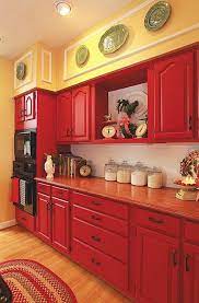 Rich Red Hues On Cabinets And Reddish Brown Countertops Give Your Country Kitchen A Comf Red Kitchen Cabinets Painted Kitchen Cabinets Colors Red Kitchen Decor