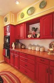 Studies shows that the color red is the hottest of the warm colors and an intense color which represents passion, love, excitement and energy to name a few. Rich Red Hues On Cabinets And Reddish Brown Countertops Give Your Country Kitchen A Comf Red Kitchen Cabinets Painted Kitchen Cabinets Colors Red Kitchen Decor