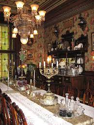 The victorian dining room showcases gorgeous stained glass windows arranged in an arched form and a yellow ceiling designed with white round medallions. Stegmaier Mansion Bed Breakfast Dining Room Victorian Victorian Interior Design Victorian Rooms