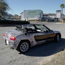 New toy! Bought a 1991 Honda Beat, a Japan-only convertible with a 660cc 3  cylinder engine that revs to 9000rpm. It's so tiny, and so much damn fun.  Wrapped it to look