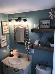A beige and taupe bathroom done with paint and tiles, a large bathtub, a turquoise shower space and a striped rug. Brown Bathroom Decor Best Bathroom Decor Blue Brown Bathroom Decor 20190530 How To Frame A Bathroom Mirror Bathroom Mirror Small Bathroom