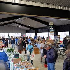 Farmers market scene showing direct sales interaction between producer and customer