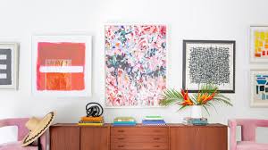 Tall silver dresser in a contemporary bedroom featuring orange tassels and styled decor. 8 Mid Century Modern Decor Style Ideas Architectural Digest