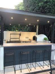 An outdoor bbq area is an outdoor kitchen or its mini version: Pizza Oven Outdoor Kitchen Fabricated Steel Frame Above An Outdoor Bar Pizza Oven And Argentinian Grill Small Outdoor Kitchens Outdoor Kitchen Bars Backyard