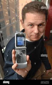 Rob Adler, CEO of go2 Media holds a cell phone displaying an example of the  company's efforts to deliver advertising and content targeted to the  interest and location of the user at