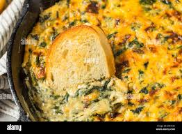 Healthy Baked Spinach Maria Dip with Cheese and Toast Stock Photo
