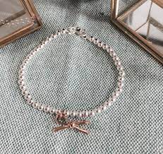Beaverbrooks Silver And Rose Gold Plated Bow Bracelet Beaverbrooks Giftswithmeaning Bow Bow Bracelet Bow Charms Rose Gold Plates