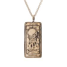 The moon tarot card shows a full moon in the night's sky, positioned between two large towers. The Moon Tarot Card Necklace Sofia Zakia