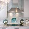 White iridescent, arabesque cooktop tiles layered on white subway tile, add a subtle yet contemporary design in a white kitchen. 1