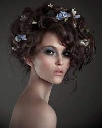 Messy Avant Garde Flowered Updo Flowers In Hair Hair Styles Curly Hair Styles