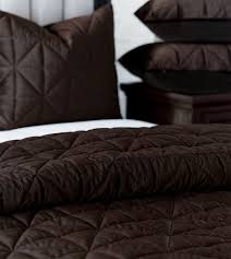 This is a more minimalistic look that starts with two bed pillows standing upright, then two standard shams, and then a trio of decorative pillows. Cocoa Brown Quilted Velvet Coverlets Shams De Medici Nova Velvet Coverlet Beige Bed Linen Luxury Bedding Sets Master Suite