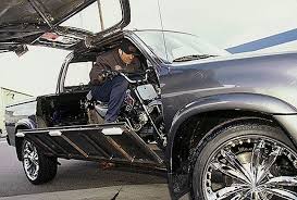 The wood chipper is attached to the back half of the car and the motor is the engine, both connected to synch up when the wood is chipping. Auto World Monster Garage