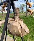 Take any brown paper bag, fill it with plastic bags, tie it ...