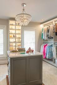 In a brilliant polished nickel finish paired with beautiful glass droplets, this distinctive design offers plenty of shimmer and sparkle. Robert Abbey Bling Chandelier Over Gray Closet Island Transitional Closet