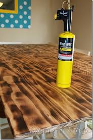 If you're working with raw pine boards, don't forget to go over the cut ends, as well. Diy Dining Table With Burned Wood Finish Using A Bernzomatic Blow Torch Keeping It Simple