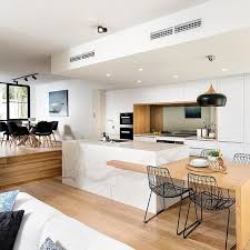 An All White Kitchen Offset With Beautiful Woodgrain Features Creating A Deceptively Kitchen Remodel Layout Modern Kitchen Design Scandinavian Kitchen Design