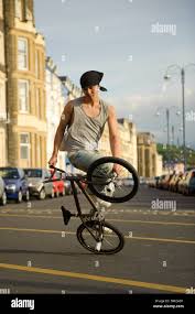 Bmx Flatland Freestyle Stunt Rider Young Man Performing Stunts On His Bmx Bike Uk Stock Photo Alamy