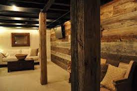 Exposed rustic pine beams custom shiplap walls inspiration for a farmhouse light wood floor and brown floor basement remodel in atlanta with white walls want a shiplap wall behind my tv, but i want it dark greys. Basement Design Ideas Pictures Remodels And Decor Rustic Basement Basement Remodeling Diy Basement