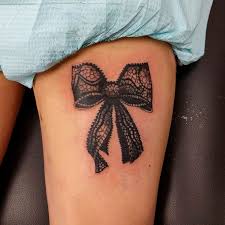 The tattoo depicts the lace making the bow as to having flower patterns that give it a distinct look. Ribbon Tattoo Design For Women Lace Bow Tattoos Lace Tattoo Design Tattoos For Women