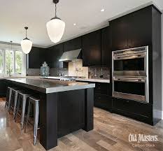 Walls are typically painted a warm beige. Black Stained Wood Kitchen Cabinets With Stainless Accents Espresso Kitchen Cabinets Black Quartz Kitchen Countertops Kitchen Cabinet Design