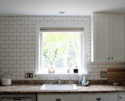 Glossy white subway tile is laid in a traditional install in this kitchen. Subway Tile Backsplash Update