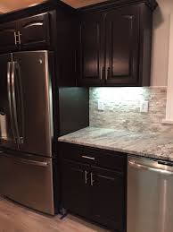 Honey Oak Cabinets Stained With General Finishes Java Gel Stain Snowflake Granite Backsplash Fro Stained Kitchen Cabinets Kitchen Cabinets Staining Cabinets