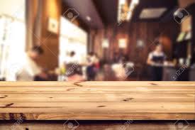 Generally the rule is that your coffee table should be the same height as your couch's seat (give or take one to two inches, but not any lower). Top Of Wood Table Counter With Blurred Coffee Shop Cafe And Restaurant Shop Interior Background Empty Table Ready For Your Product Display Or Montage Vintage Effect Tone Stock Photo Picture And