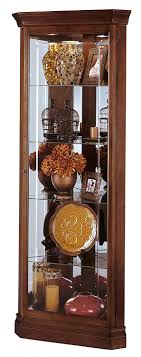 These are typically narrow and tall. Accent Furniture Howard Miller Lynwood Corner Curio Cabinet 680 345 Windsor Cherry Glass Case With Light Display Curio Cabinets
