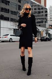 Blonde Woman Wearing Black Sweater Dress Black Tall Boots Black Clutch Handbag Fashion Jackson San Diego Fashion Blogger Street Fashion Jackson Fashion Outfits