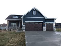 For the door to close correctly without reversing, the safety sensors need to be aligned perfectly, and there should be nothing in the way of the light beam. Blue Exterior Siding Brown House Exterior Blue Siding House House Paint Exterior